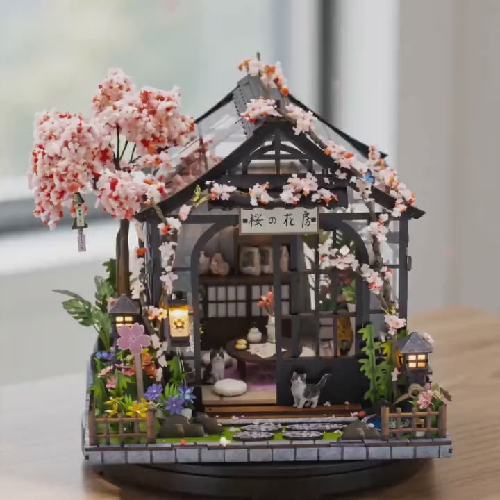 The Sakura Teahouse DIY miniature kit showcase, lit and rotating on a bright tabletop