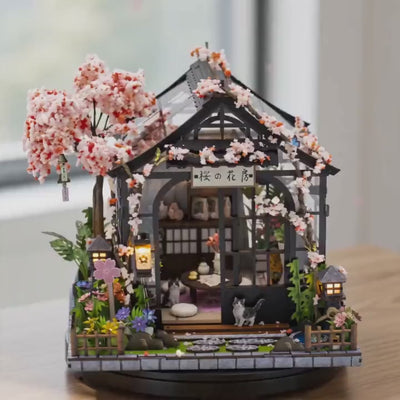 The Sakura Teahouse DIY miniature kit showcase, lit and rotating on a bright tabletop