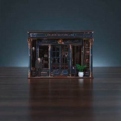 The Tailor's Atelier miniature bespoke menswear boutique showcase, lights glow to life
