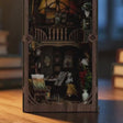 The Artist's Studio book nook showcase, lights glowing to life
