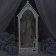 The Wedding Chapel book nook showcase, chandelier and rose window glowing warm