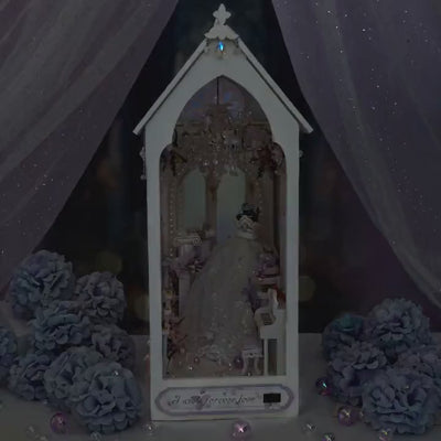 The Wedding Chapel book nook showcase, chandelier and rose window glowing warm