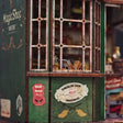 The Enchantment Shop kit showcase, the lit green wizard's magic shopfront glowing to life