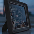 The Dressmaker's Shop miniature book nook showcase, lights glowing to life