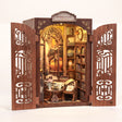 Hands assembling The Book Emporium book nook, ending with the LED lights switching on