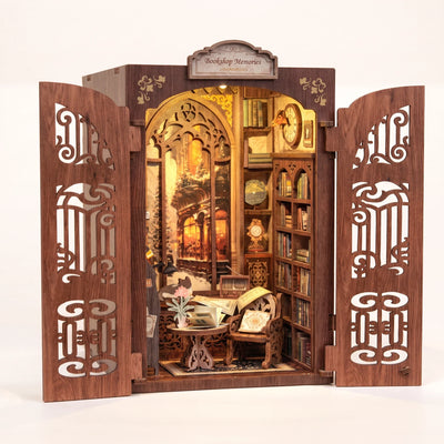 Hands assembling The Book Emporium book nook, ending with the LED lights switching on