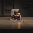 The Writer's Room miniature roombox showcase, lamp glowing to life