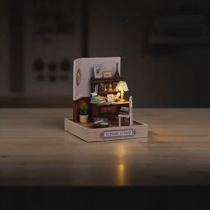 The Writer's Room miniature roombox showcase, lamp glowing to life