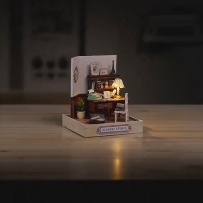 The Writer's Room miniature roombox showcase, lamp glowing to life