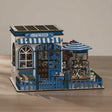 The Santorini Café miniature coffee shop showcase, lights glowing warm