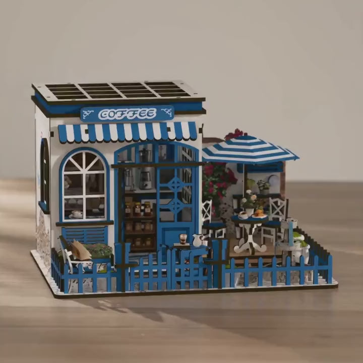 The Santorini Café miniature coffee shop showcase, lights glowing warm