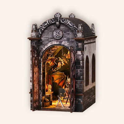 Hands assembling The Dragon's Keep book nook, ending with the firelight LED glow switching on