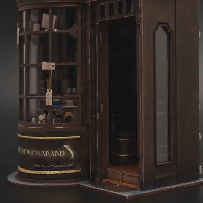 The Wand Shop book nook showcase, warm lights glowing to life over shelves of wand boxes