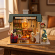The Christmas Parlour miniature roombox showcase, lights glowing to life