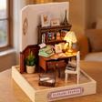 The Writer's Room miniature roombox showcase, lamp glowing to life