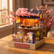 The Ramen Stall miniature kit showcase, lantern and counter glowing at dusk