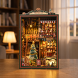 The Christmas Shop DIY book nook kit, lights glowing to life in a cinematic showcase