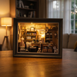 The Dressmaker's Shop miniature book nook showcase, lights glowing to life