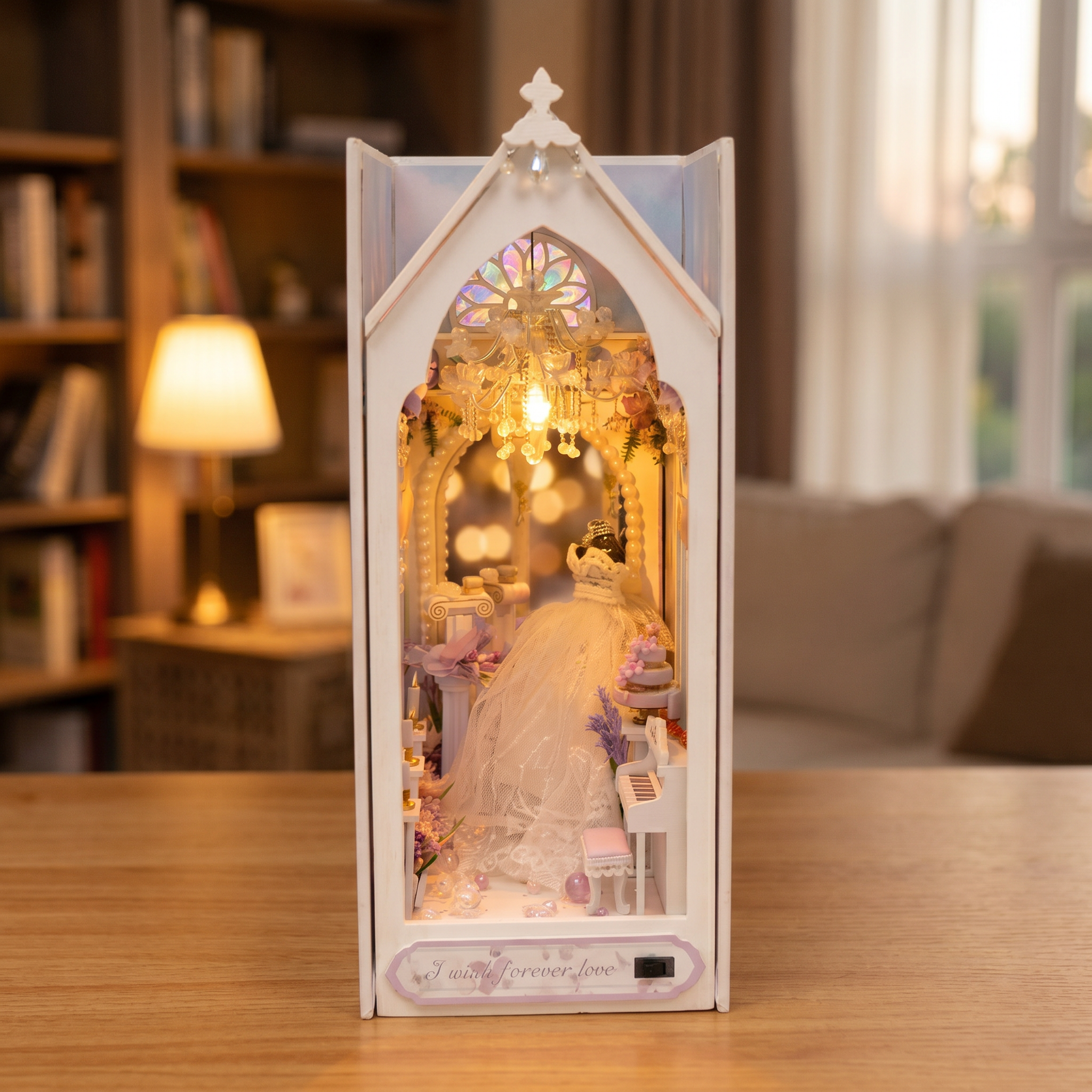 The Wedding Chapel book nook showcase, chandelier and rose window glowing warm