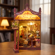 Hands assembling The Serenade book nook kit, ending with the LED lights switching on