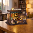 Hands assembling The Witching Hour miniature magic cafe kit