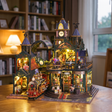 Hands assembling The Clocktower Emporium kit, LED lights turning on
