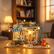 Hands assembling The Pet Club miniature kit, ending with the LED lights switching on