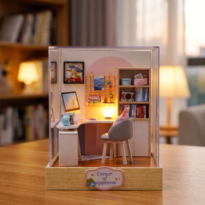 Assembling The Daydream Desk miniature study corner: hands build the kit and switch on the lamp