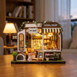 Hands assembling The Puppy Pantry miniature kit, ending with the lights switching on