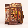 The Record Shop book nook assembled by hand, then the warm interior lights come on behind the gold Memories sign