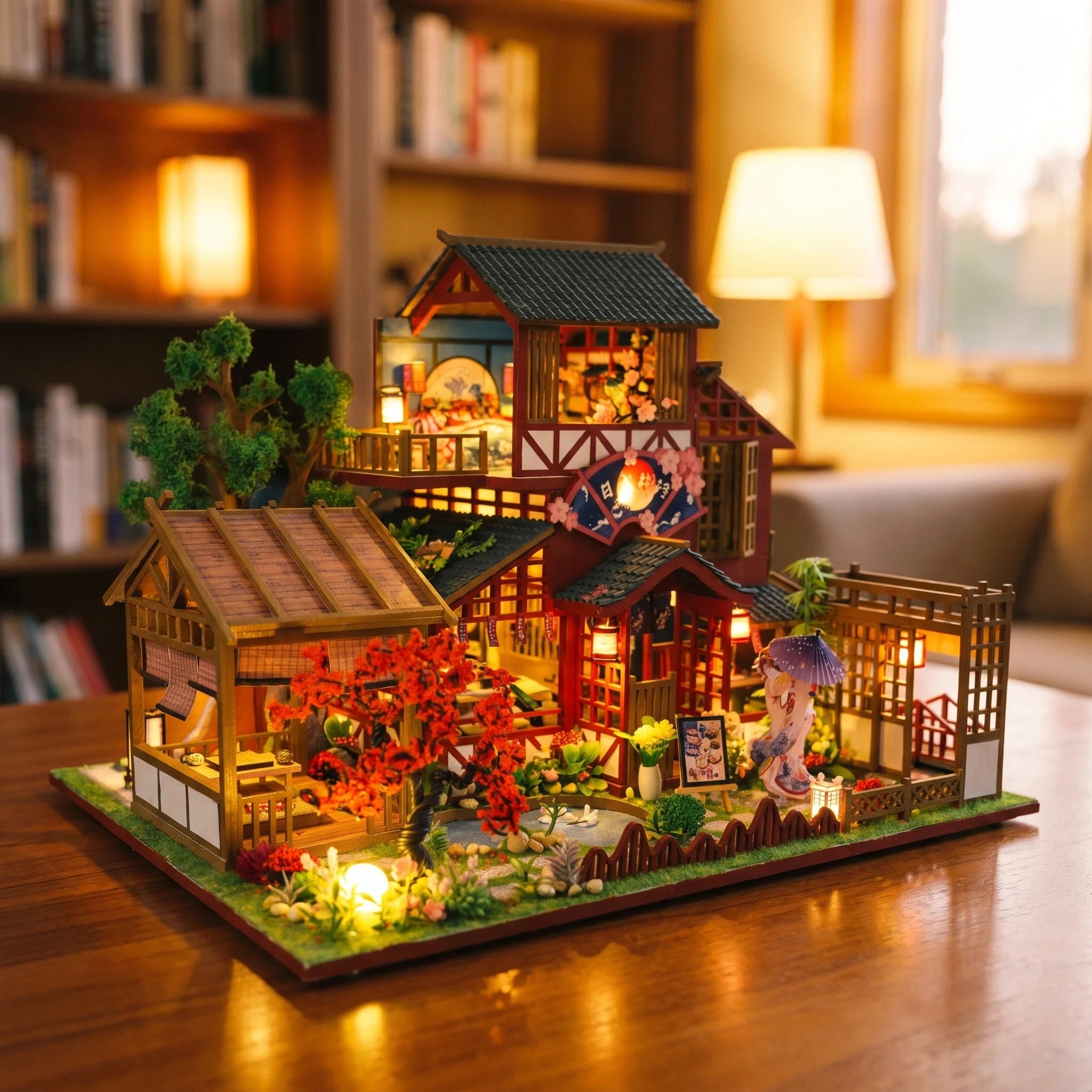 Hands assembling The Autumn Courtyard kit, ending with the LED lights switching on
