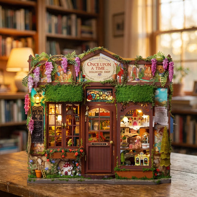 Hands assembling The Dollhouse Shop miniature kit, ending with the LED lights switching on
