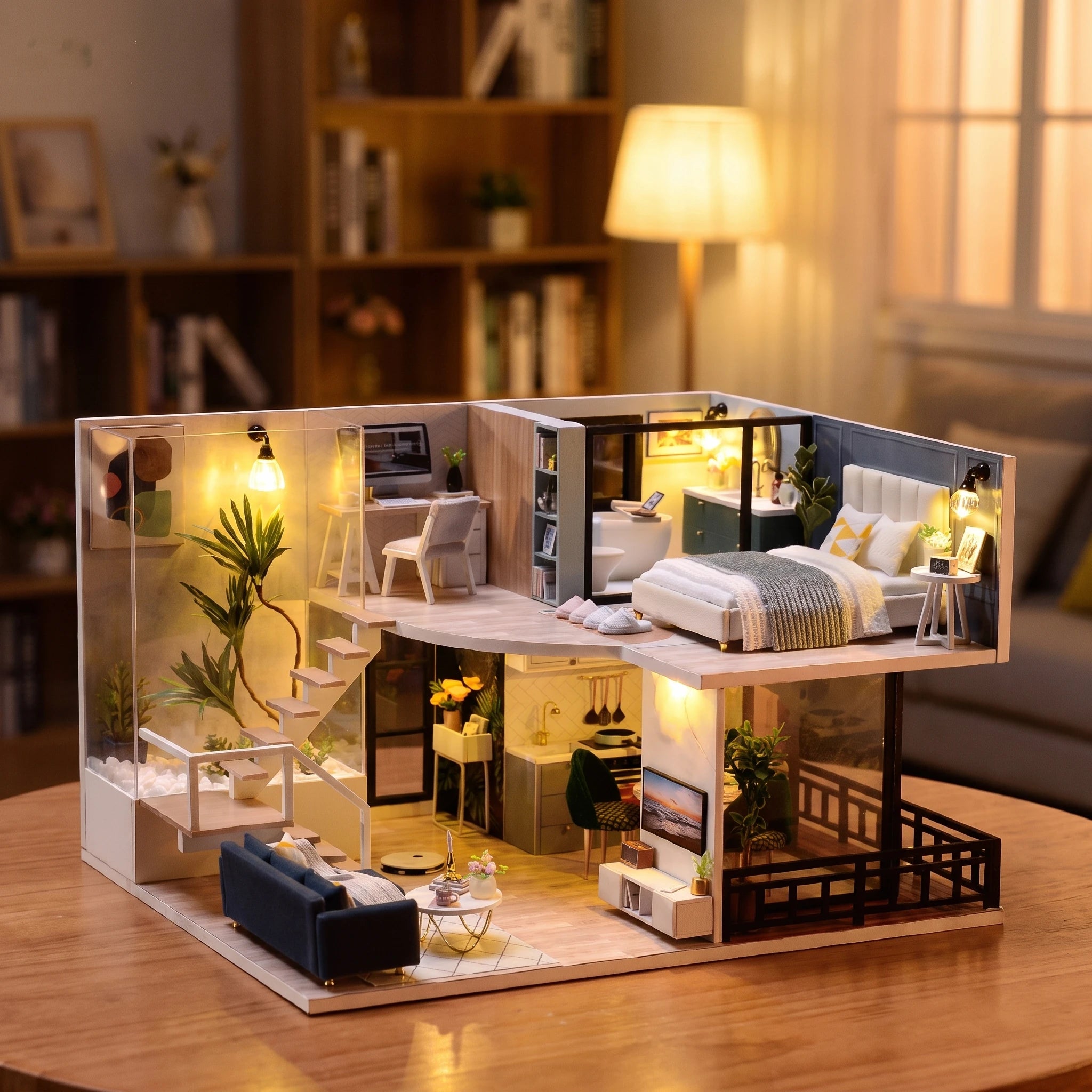 Hands assembling The Nordic Loft miniature kit, ending with the lights switching on