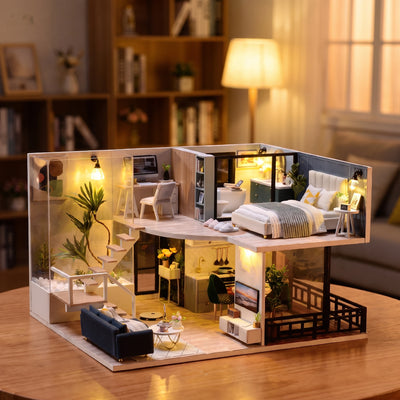 Hands assembling The Nordic Loft miniature kit, ending with the lights switching on