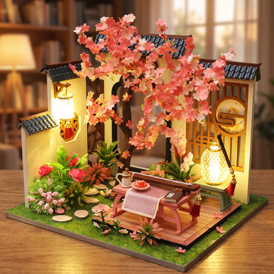 Hands assembling The Petal Courtyard miniature kit, ending with the lights switching on