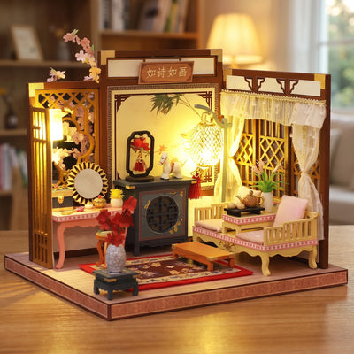 Hands assembling The Poet's Chamber miniature kit, ending with the lights switching on