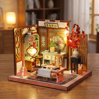 Hands assembling The Scholar's Study miniature kit, ending with the lights switching on