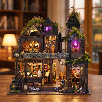 Hands assembling The Witch's Lair miniature kit, ending with the LED lights turning on