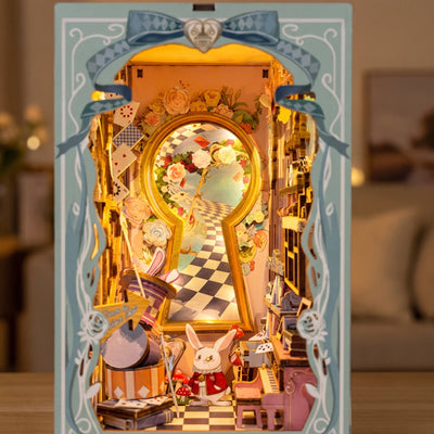 Hands assembling The Wonderland Keyhole book nook, ending with the touch light switching on