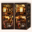 The Repair Shop DIY book nook kit on a cream background, lights on