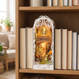 The Tabby Terrace at its real size on a bookshelf between hardcover books