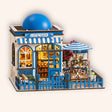 The Santorini Café miniature blue-and-white Greek coffee shop roombox on a soft cream background with warm LED lighting