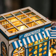 Close-up of the slatted skylight roof, COFFEE sign and striped awning of The Santorini Café miniature