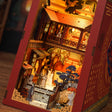 The Tang Palace book nook, layered printed wooden panels building depth in the courtyard scene