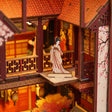 The Tang Palace upper balcony with a printed figure panel beside red lattice railings