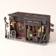 The Alchemist's Cafe DIY miniature coffee shop kit, assembled with LED lights on