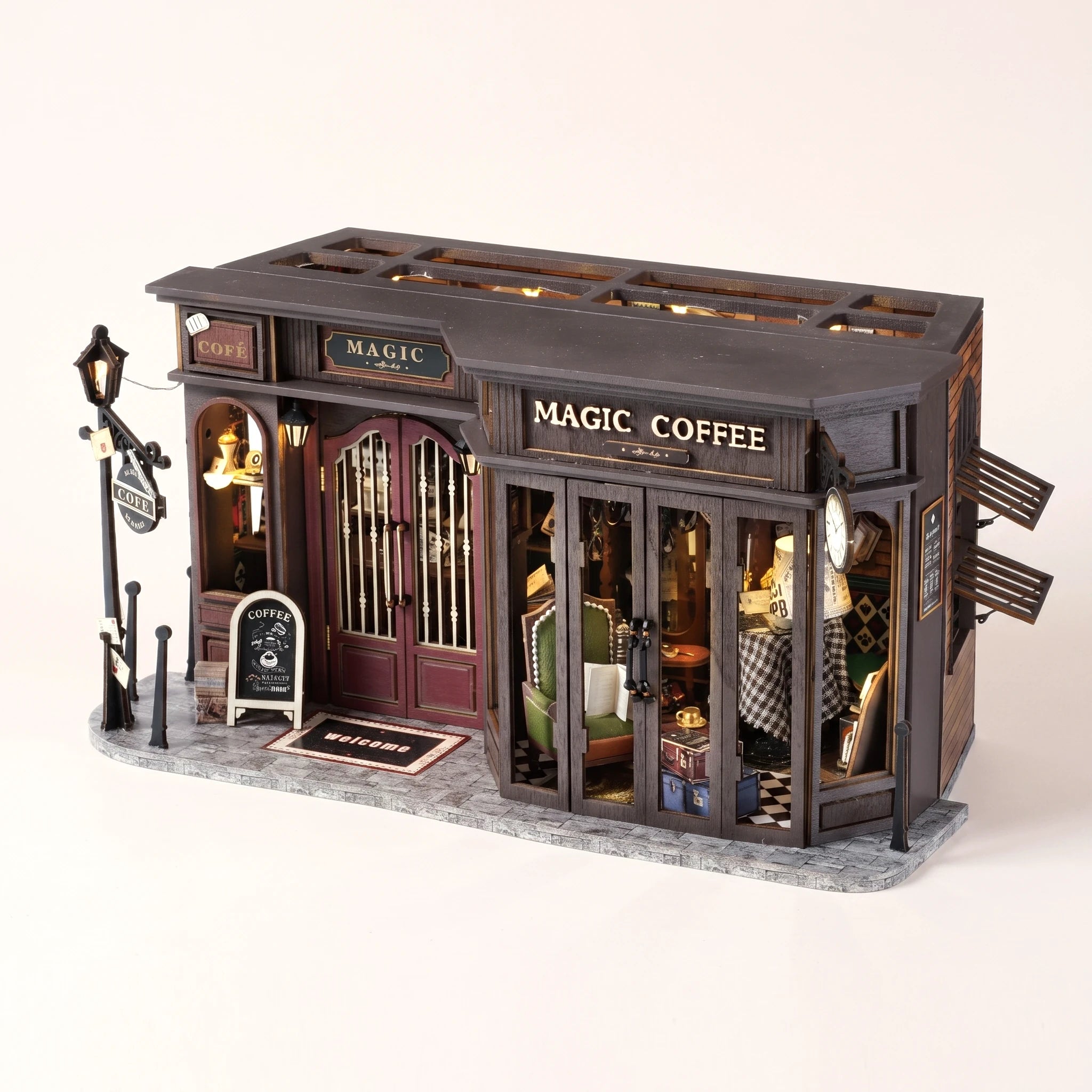 The Alchemist's Cafe DIY miniature coffee shop kit, assembled with LED lights on