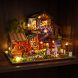 The Autumn Courtyard glowing on a walnut shelf at night