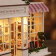 Shop window detail: cake stands glowing behind the panes