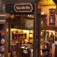Macro of the lamplit shopfront of The Bewitched Bean
